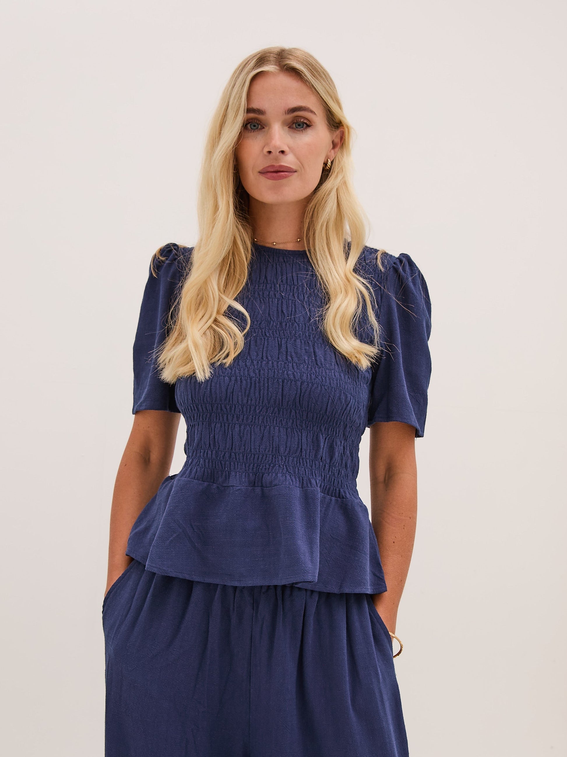 Marina Navy Peplum Top by Fika - Bare Fashion